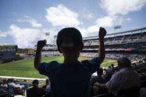 A child cheering at a ballpark.