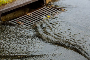 Water rushing into a storm sewer drain.