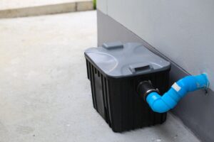A grease trap box outside.